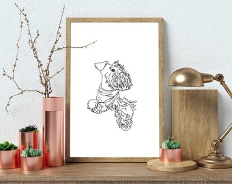 May include: A black and white line art print of a dog looking up. The print is framed in a light brown frame and is hanging on a white wall. There are several small potted plants in front of the print.