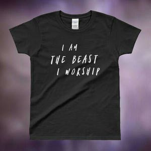 May include: Black t-shirt with white text that reads "I am the beast I worship".