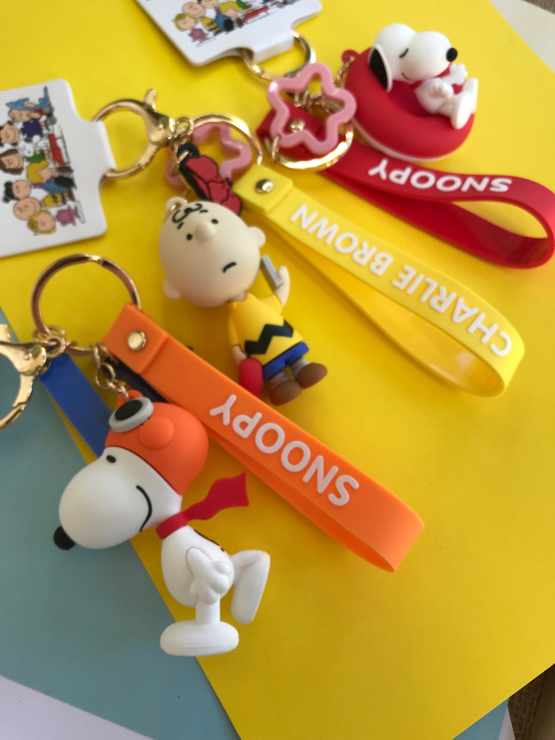 Peanuts PVC Key Chain With Embossed Wrist Strap and Bell - Snoopy Flyi