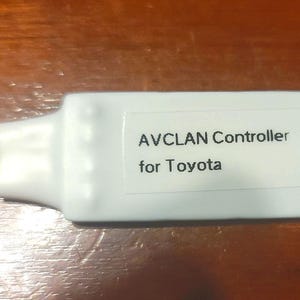 May include: White AVCLAN Controller for Toyota with four wires, red, black, blue, and yellow.