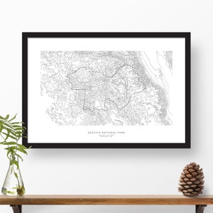 May include: A black and white line art print of Sequoia National Park in California. The print shows the park's topography with contour lines. The text "SEQUOIA NATIONAL PARK" is printed below the map.