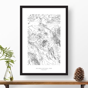 May include: Black and white line art print of Big Bend National Park in Texas. The print shows the topography of the park with elevation lines. The text "Big Bend National Park" is at the bottom of the print.