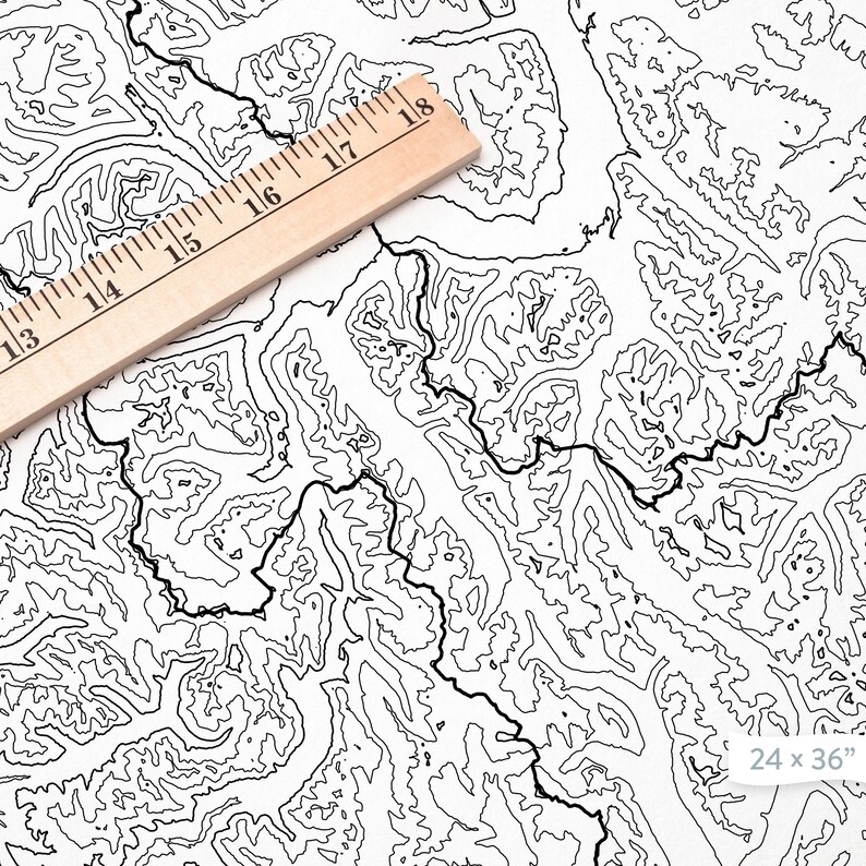 May include: Black and white topographic map print with contour lines. A wooden ruler is placed diagonally across the map, showing measurements in inches. The print is labeled "24 x 36" (approx. 61 x 91 cm).