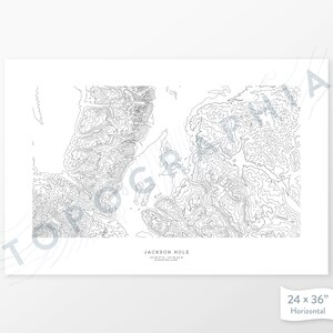 May include: A black and white topographic map print of Jackson Hole, Wyoming. The print shows the elevation contours of the area. The print is 24 inches by 36 inches and is horizontal.