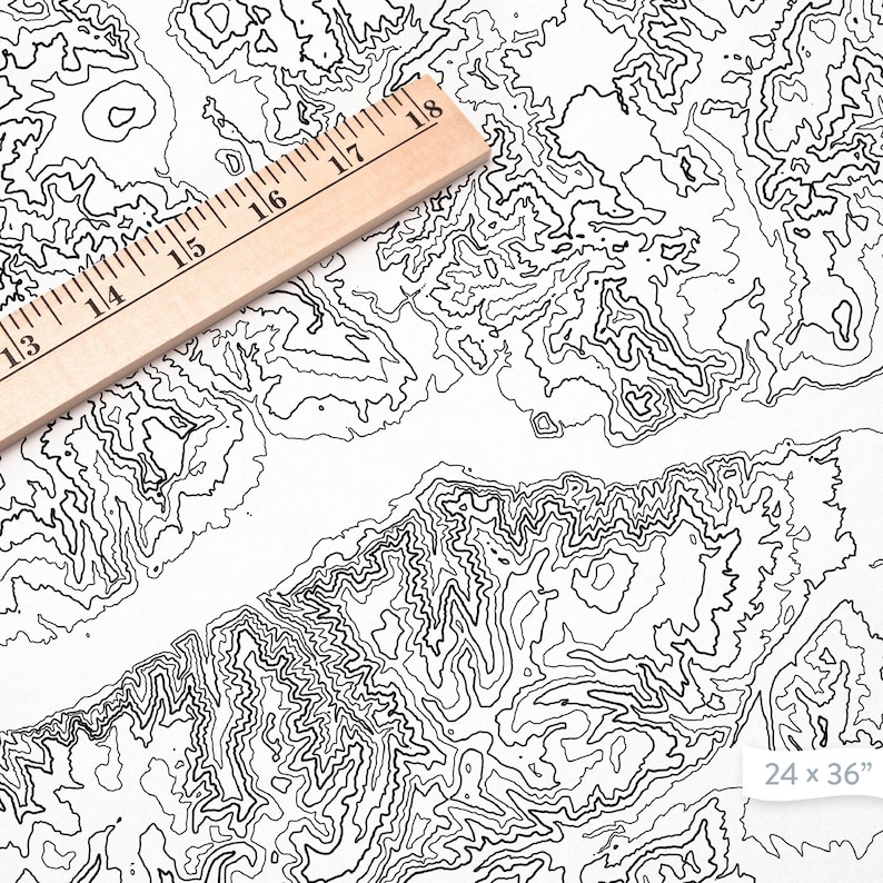 May include: A black and white topographic map print with a ruler on top. The map shows a mountainous region with contour lines. The print measures 24 x 36 inches.