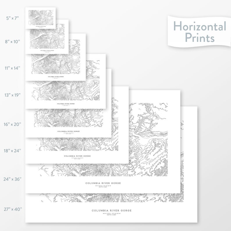 May include: A set of eight different sized prints of a black and white topographic map of the Columbia River Gorge. The prints are arranged in a staggered pattern, with the largest print at the bottom and the smallest print at the top. The prints are all on white paper and have a white border.