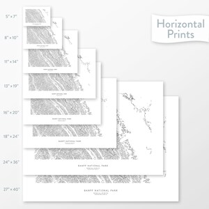 May include: A selection of horizontal prints displaying detailed black and white topographical maps of Banff National Park. The prints are available in various sizes, from 12.7cm x 17.8cm to 68.6cm x 101.6cm, with the text "Horizontal Prints" in the upper right corner.