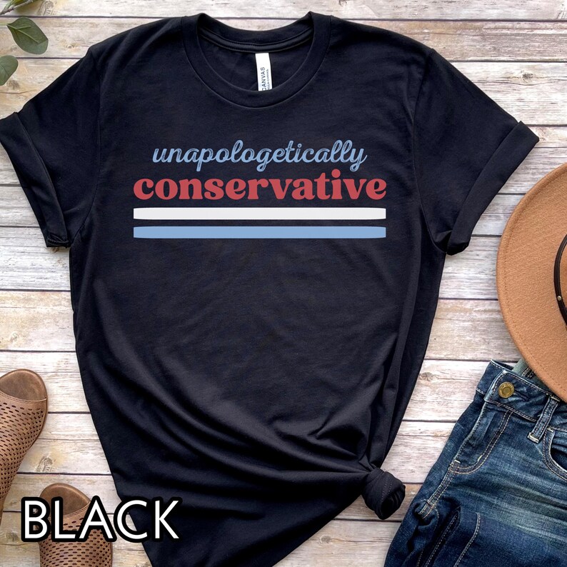 May include: Black t-shirt with the words "unapologetically conservative" in blue and red, with a blue and white stripe design. The word "BLACK" is printed at the bottom of the shirt.
