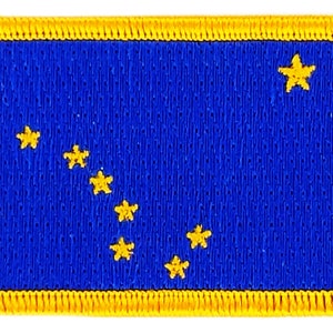 以下が含まれることがあります： 黄色の縁取りと黄色の北斗七星の輪郭が描かれた青い布のパッチ
