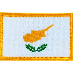 May include: A yellow and white embroidered patch with the flag of Cyprus. The flag features a white background with a yellow map of Cyprus and two green olive branches.