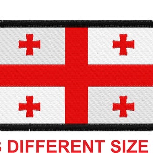 May include: A white patch with a red cross in each corner and a larger red cross in the center. The patch has a black border and a frayed edge. The text "3 DIFFERENT SIZE" is printed below the patch.