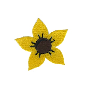 May include: A yellow embroidered sunflower patch with a brown center.