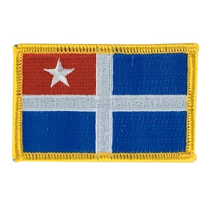 May include: A blue, white and red embroidered patch with a white star in the red section. The patch has a yellow border.