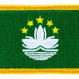 May include: Embroidered patch featuring the flag of Macau. The rectangular patch has a green background with a white lotus flower and five yellow stars. A gold border surrounds the patch.