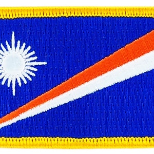 May include: A blue embroidered patch featuring a white starburst and a diagonal orange and white stripe. The patch is edged with a yellow border.