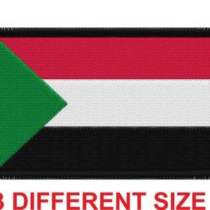 May include: An embroidered patch featuring the flag of Sudan. The patch is black, white, red and green with a fringed border.