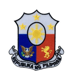 May include: Embroidered patch featuring the coat of arms of the Philippines. The patch is white with a blue and red shield, a yellow sun, three yellow stars, and a yellow eagle and lion. The text "REPUBLIKA NG PILIPINAS" is written in a black scroll.