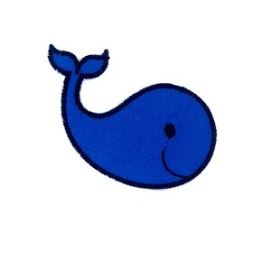 May include: A blue whale applique with a black outline and a single black eye. The whale has a smiling mouth.