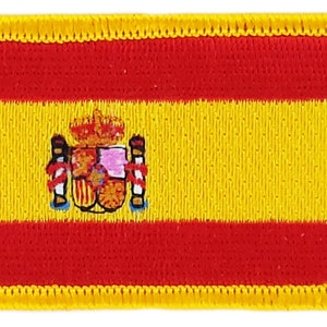 May include: A red and yellow embroidered patch with the coat of arms of Spain in the center.