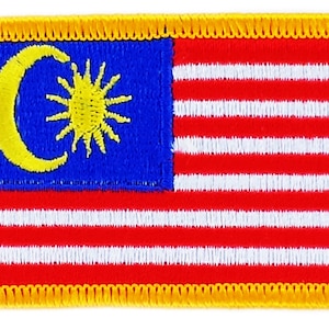 May include: A yellow embroidered patch with the flag of Malaysia. The flag features a blue field with a yellow crescent moon and a 14-pointed star, and 14 alternating red and white stripes.