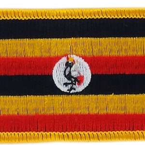 Könnte beinhalten: Ein gestickter Aufnäher mit der Flagge von Uganda. Die Flagge ist schwarz, gelb und rot mit einem weißen Kreis in der Mitte, der einen Kranich enthält.