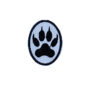 May include: Black paw print embroidered on a white circle patch.