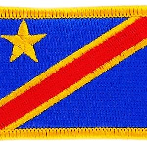 May include: A blue fabric patch with a yellow star and a diagonal red stripe with yellow borders. The patch is surrounded by a yellow border.