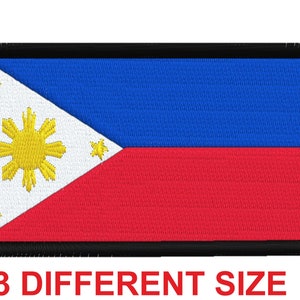 May include: A black-bordered embroidered patch featuring the flag of the Philippines. The flag has a white triangle with a yellow sun and three stars, a blue upper stripe, and a red lower stripe.