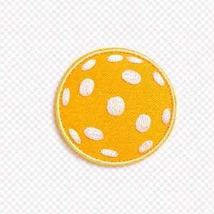 May include: A round, yellow patch with white embroidered dots. The patch has a yellow border and is likely an iron-on or sew-on patch for clothing or accessories. The design is simple and playful, suitable for various applications.