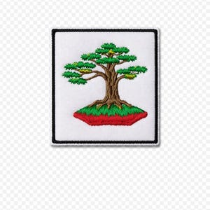 May include: Embroidered patch featuring a bonsai tree design. The tree has green foliage and a brown trunk, set against a white background. The patch is bordered with a black stitched edge, and the base of the tree is on a red and green mound.