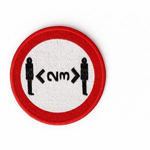 May include: Circular patch with a red border and a white centre. The patch shows black silhouettes of two people with an arrow and the text "<2m>" between them, indicating a social distancing guideline.