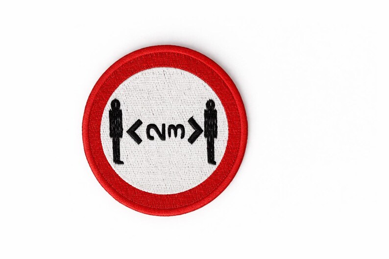 May include: Circular patch with a red border and a white centre. The patch shows black silhouettes of two people with an arrow and the text "<2m>" between them, indicating a social distancing guideline.