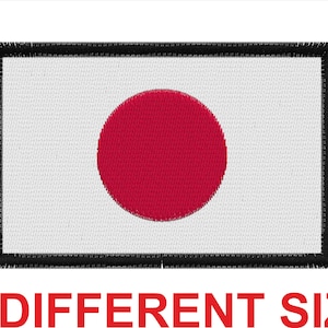 May include: A white embroidered patch with a red circle in the center. The patch has a black border and is a representation of the Japanese flag.