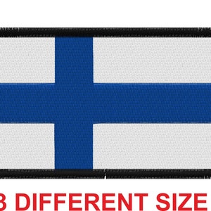 May include: A blue and white Finnish flag patch with a black border. The flag is made of fabric and has a stitched edge.