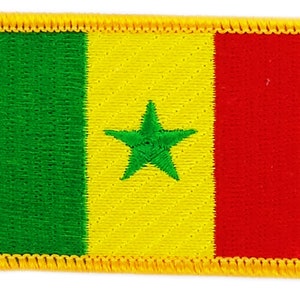 May include: A green, yellow, and red fabric patch with a green five-pointed star in the center. The patch has a yellow border.