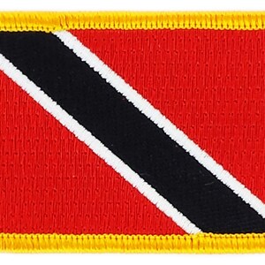 May include: A red, black, and white embroidered patch with a yellow border. The patch features the flag of Trinidad and Tobago.