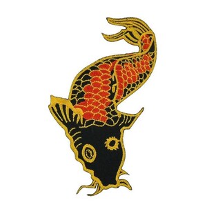 May include: Embroidered patch featuring a koi fish design. The patch has a black head and tail, with a red and orange body. The edges and details are outlined in gold. The koi fish is a symbol of good fortune and perseverance.