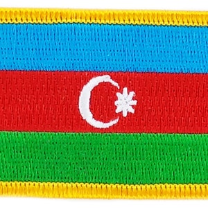 May include: A rectangular embroidered patch with the flag of Azerbaijan. The flag features a blue, red, and green horizontal tricolor with a white crescent moon and star in the center.