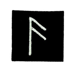 May include: A black square patch featuring a white embroidered rune symbol. The rune is a vertical line with two diagonal lines extending from it. The patch has a textured appearance.