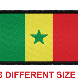 May include: A green, yellow, and red embroidered patch with a green star in the center. The patch has a black border and is likely a flag.