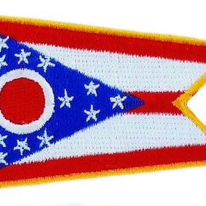 May include: Embroidered patch featuring the flag of Ohio. The design includes a blue triangle with white stars, a red circle with a white border, and red and white stripes. The patch has a gold border.