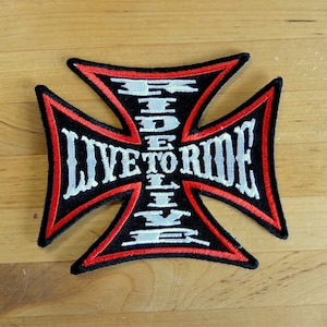 May include: A black and red embroidered patch with a white cross and the text "Live to Ride" in a stylized font.