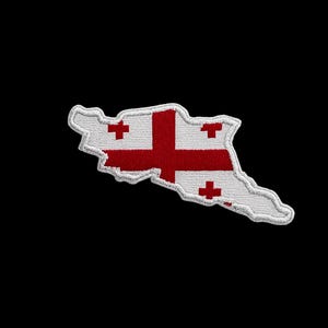 May include: Embroidered patch in the shape of Georgia, featuring a white outline and a red and white flag design. The flag has a large red cross and four smaller red crosses. The patch is set against a black background.