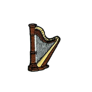 Puede incluir: Un arpa de madera marrón con cuerdas doradas. El arpa es un instrumento musical.