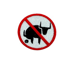 May include: Embroidered patch with a black bull silhouette crossed out with a red line, inside a red circle. The patch has a white background and a black bull graphic.