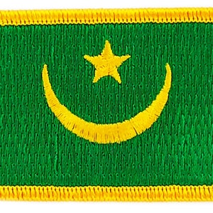 May include: A green fabric patch with a yellow crescent moon and star in the center. The patch has a yellow border.