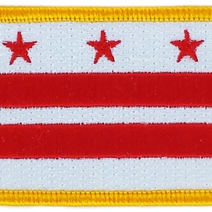 May include: A white patch with three red stars and three red horizontal stripes, surrounded by a yellow border.