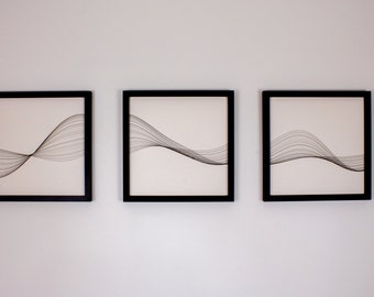 May include: Three black framed prints with white backgrounds and black line drawings of abstract waves.