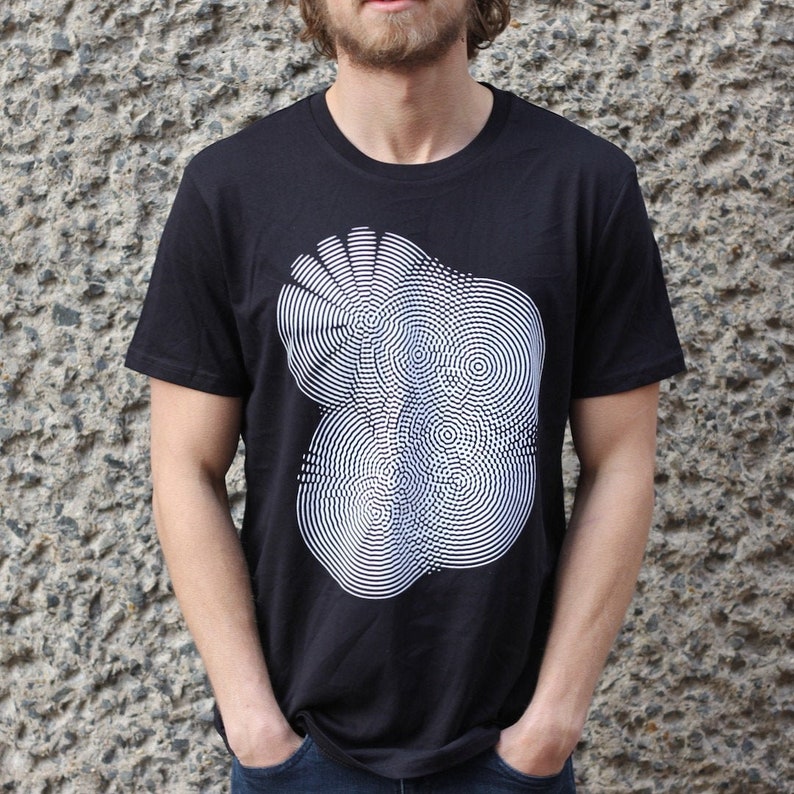 May include: A black t-shirt with a white graphic design of a circular pattern.