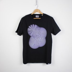 May include: Black t-shirt with a white and purple graphic print of a circular design. The shirt has a crew neck and short sleeves. The brand name "I-D" is printed on the tag.